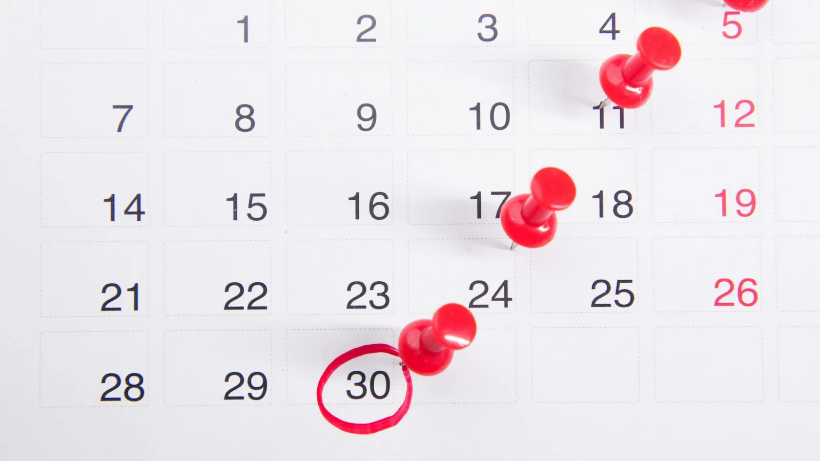 Calendar with red pins marking dates
