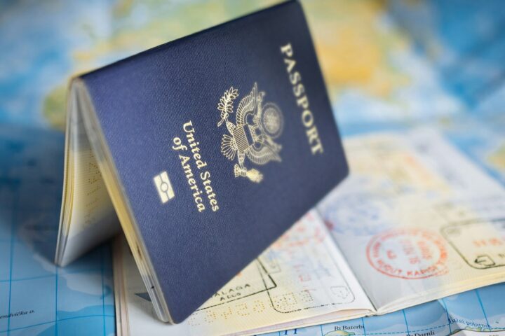 United States passport standing open on a world map