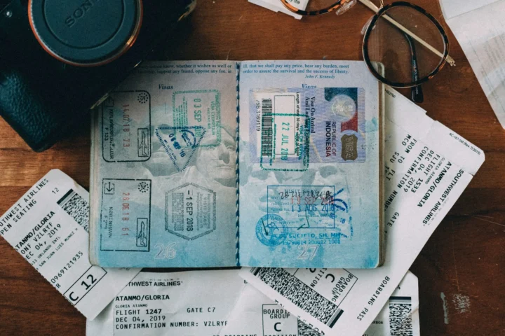 Passports, boarding passes and a camera on a table