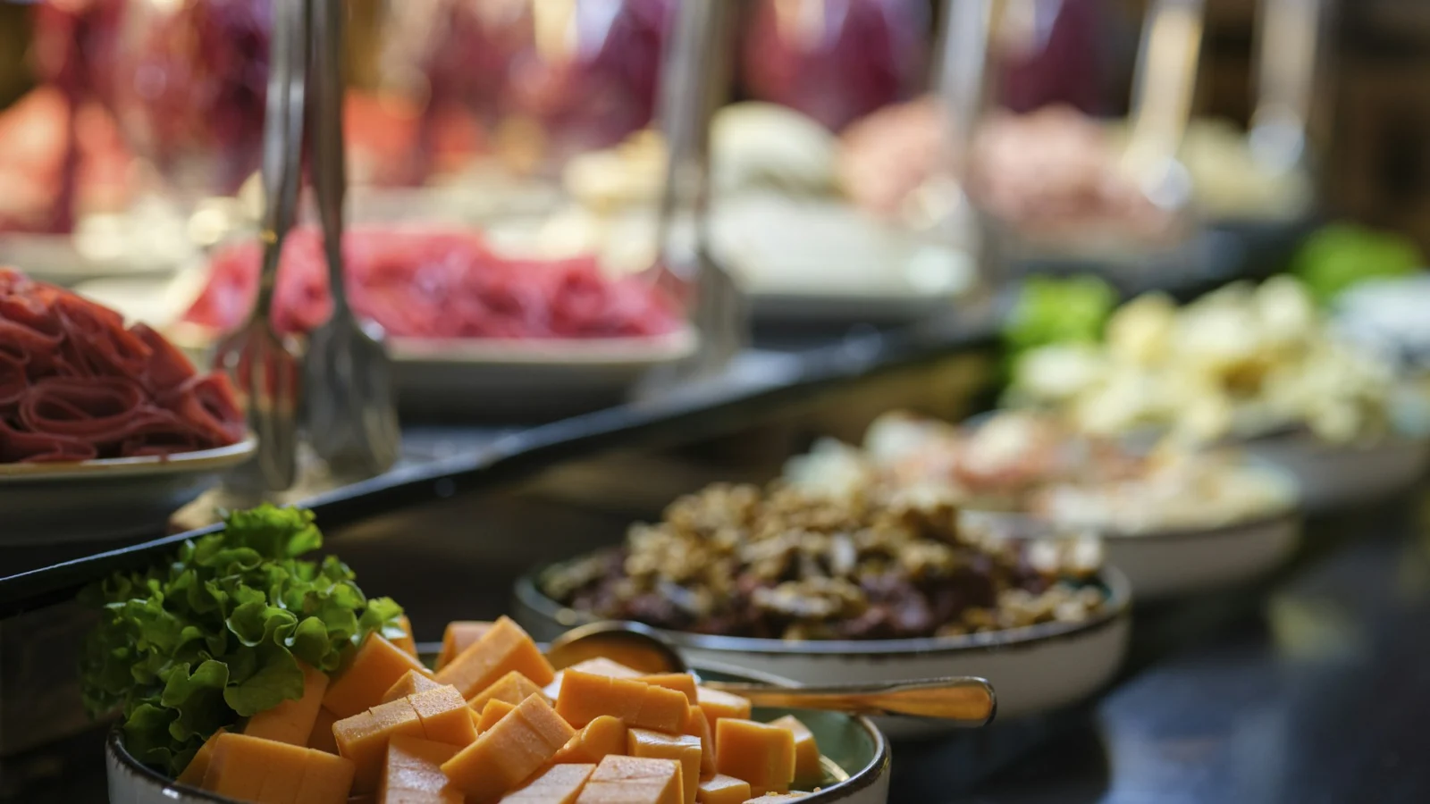 Buffet counter with cheese, salads and meats