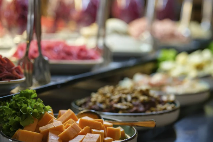 Buffet counter with cheese, salads and meats
