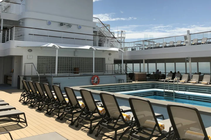 Sun loungers around the pool on a cruise ship deck